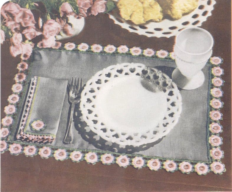 Gray place mats with rose border and napkins #816, as photographed in the 1951 leaflet.